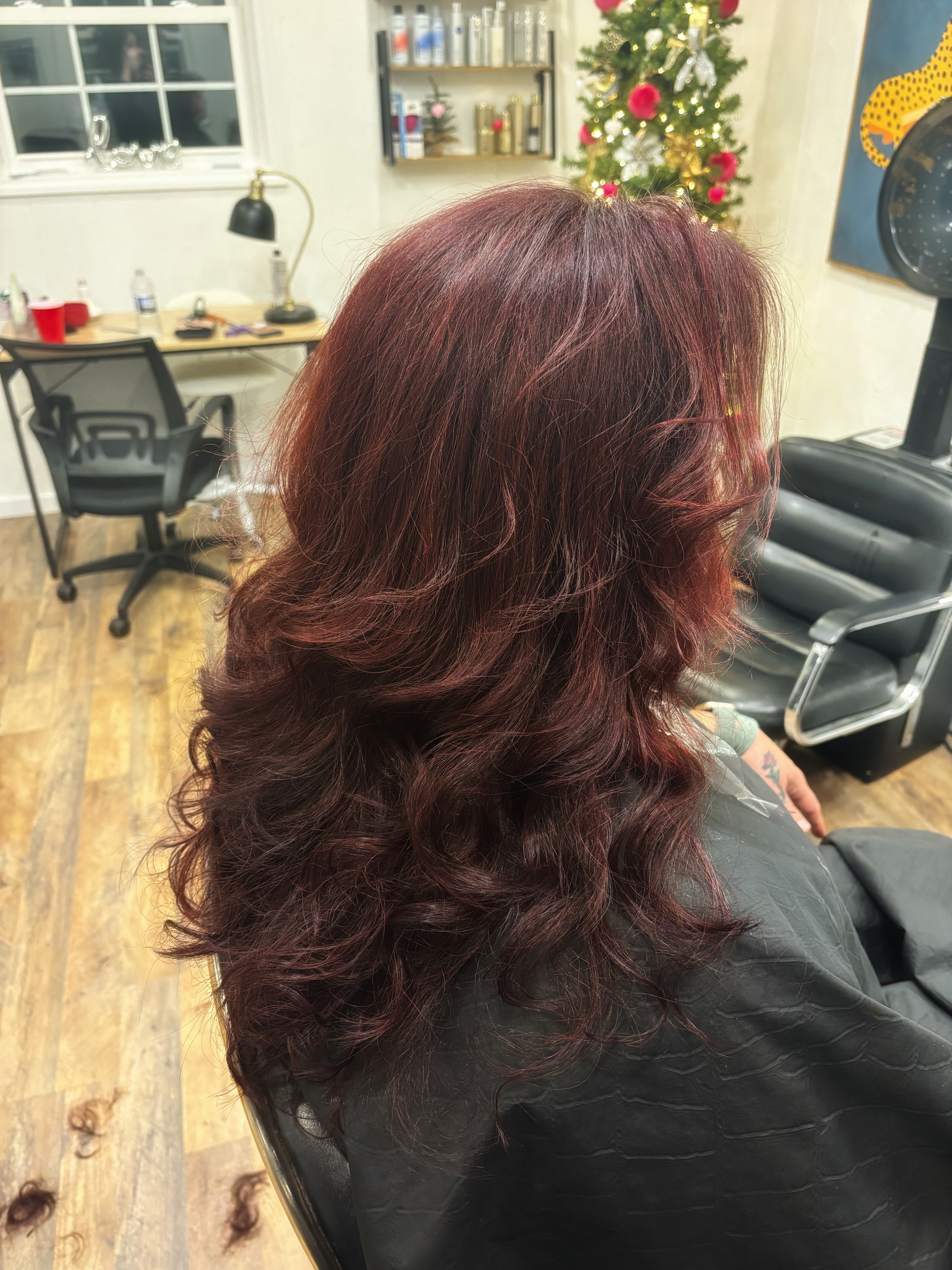 Burgundy color and curls at Salon Misty